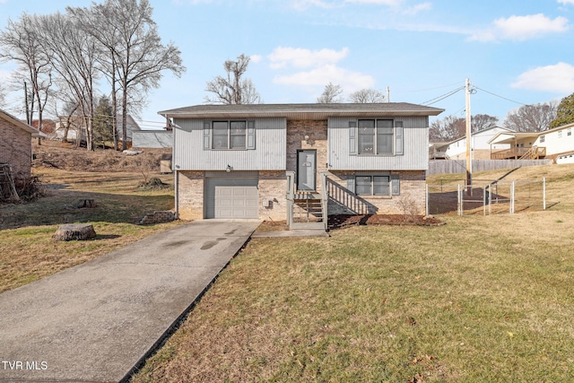 bi-level home with a garage and a front yard