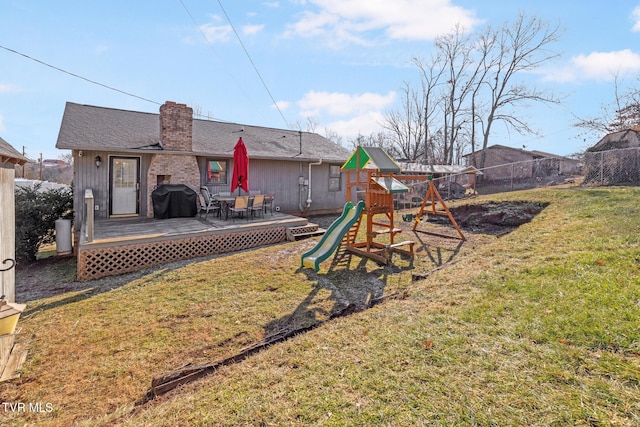 view of yard featuring a playground and a wooden deck