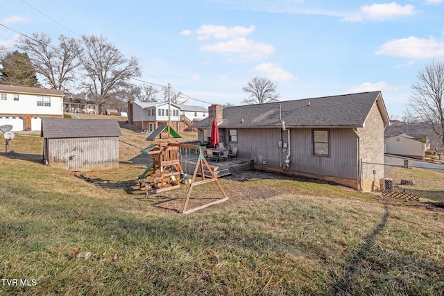 view of yard with a playground and a storage unit