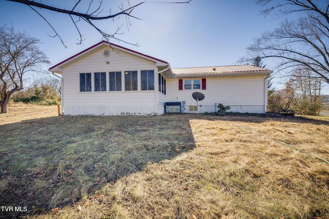 view of front of property with a front lawn and a sunroom