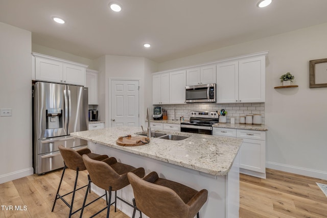 kitchen featuring sink, stainless steel appliances, and white cabinets