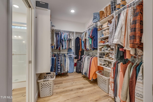 spacious closet with light hardwood / wood-style floors