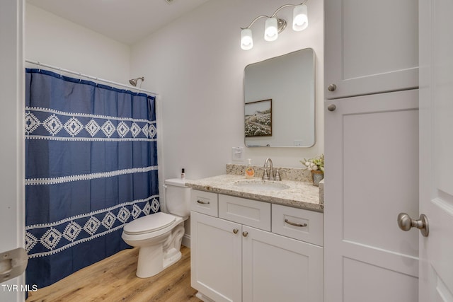 bathroom featuring vanity, hardwood / wood-style floors, a shower with curtain, and toilet