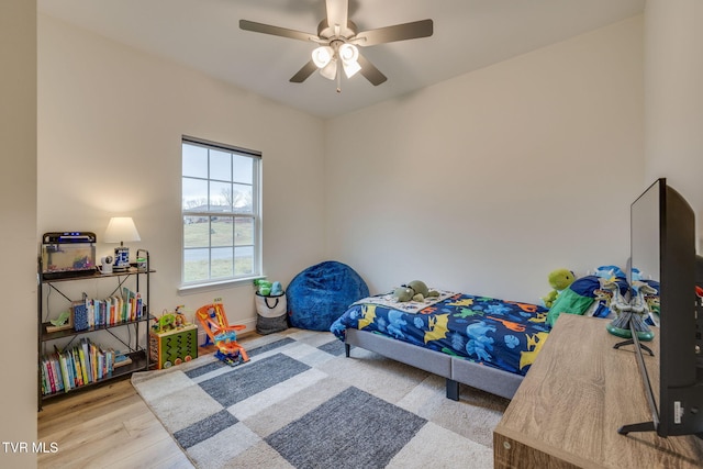 bedroom with ceiling fan and light hardwood / wood-style flooring