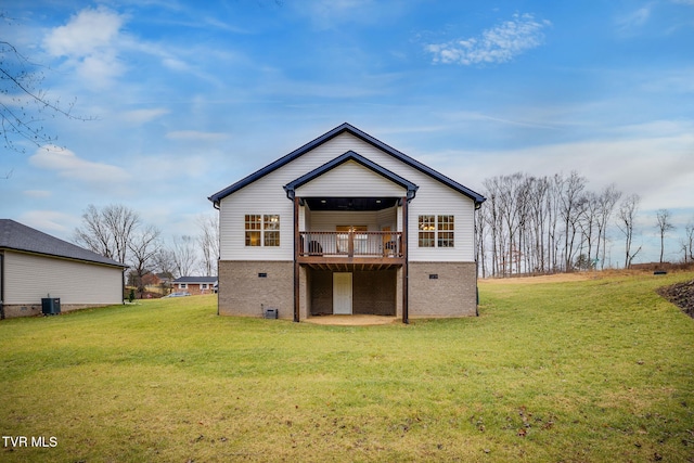 back of property with a deck and a lawn