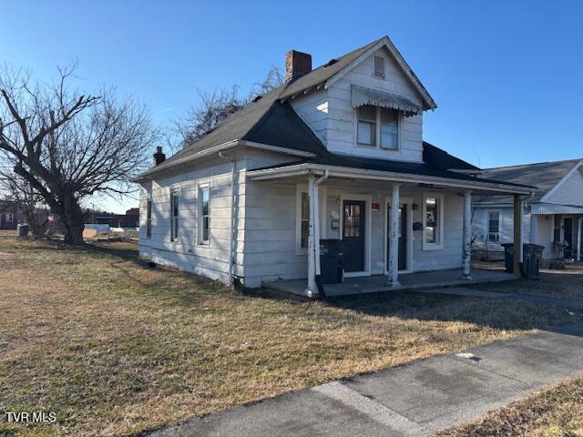 bungalow featuring a front yard and covered porch