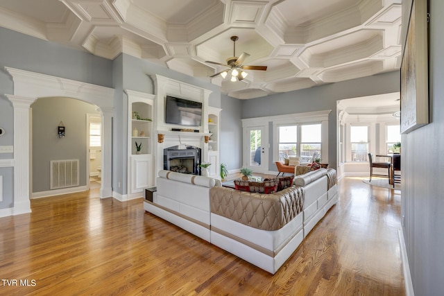 living room featuring coffered ceiling, hardwood / wood-style flooring, decorative columns, and ceiling fan