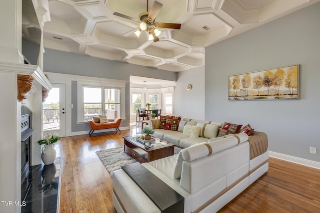 living room with beamed ceiling, coffered ceiling, hardwood / wood-style floors, and ceiling fan