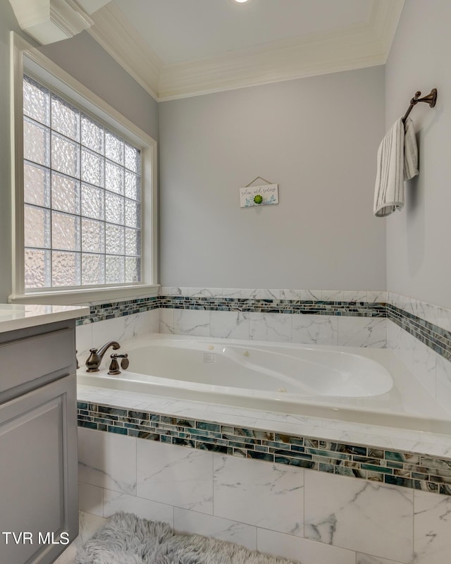 bathroom featuring vanity, tiled tub, and ornamental molding