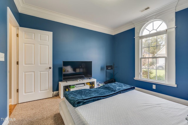 bedroom with crown molding and light colored carpet