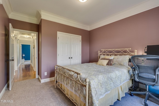 bedroom with crown molding, a closet, and carpet