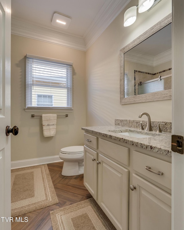 bathroom with ornamental molding, parquet flooring, vanity, and toilet