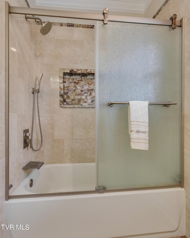 bathroom with bath / shower combo with glass door