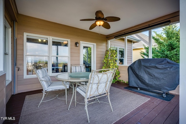 sunroom featuring ceiling fan