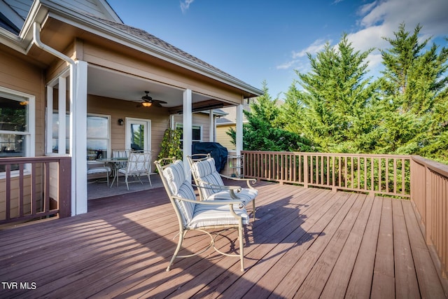 wooden deck featuring ceiling fan and a grill