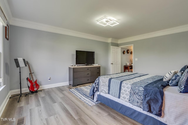 bedroom with ornamental molding and light wood-type flooring