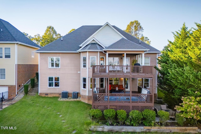 rear view of property with a wooden deck, a yard, and cooling unit