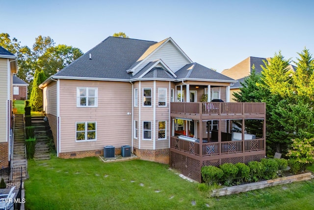 rear view of property featuring a wooden deck, a yard, and central air condition unit