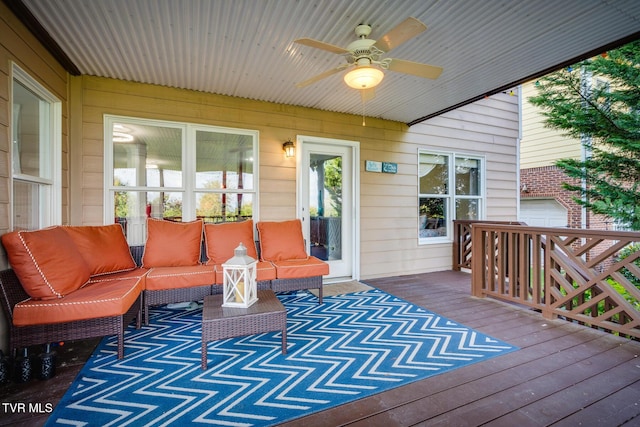 wooden deck with outdoor lounge area and ceiling fan