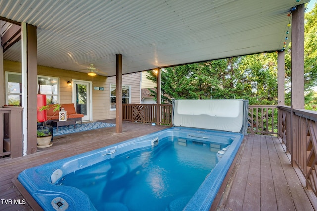 view of swimming pool featuring a deck