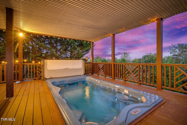 pool at dusk with a wooden deck