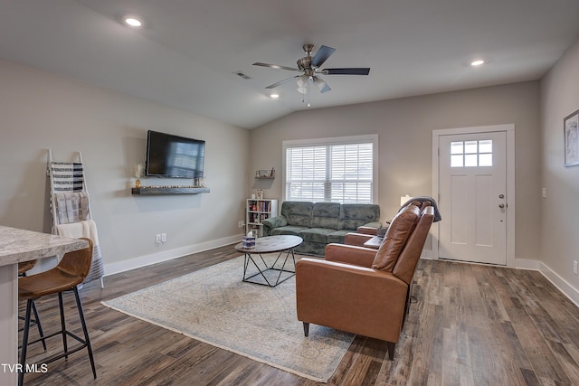 living room with lofted ceiling, dark wood-type flooring, and ceiling fan