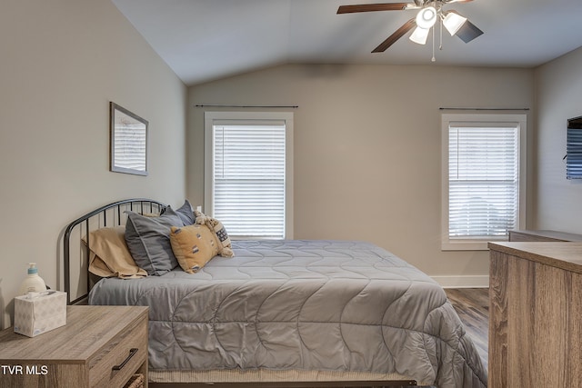 bedroom with ceiling fan, wood-type flooring, and vaulted ceiling