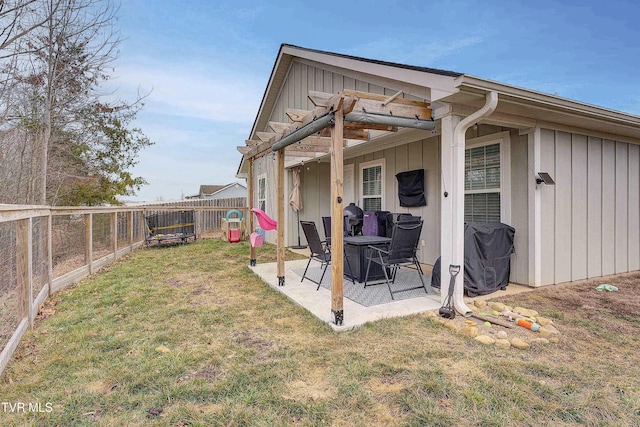 back of house with a pergola, a patio area, and a lawn