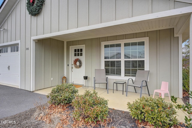 property entrance featuring a porch and a garage