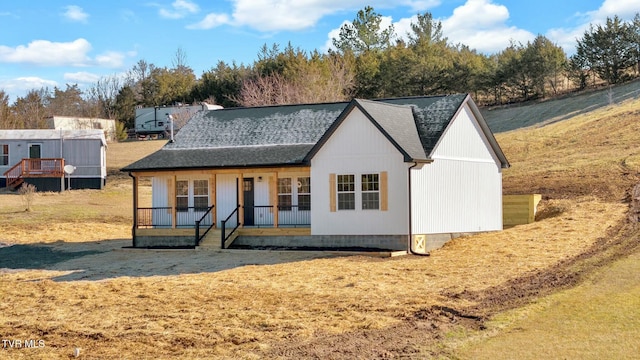 view of front of house with a front yard and covered porch