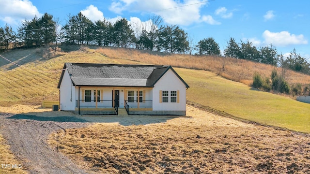 ranch-style home with a porch and a front yard