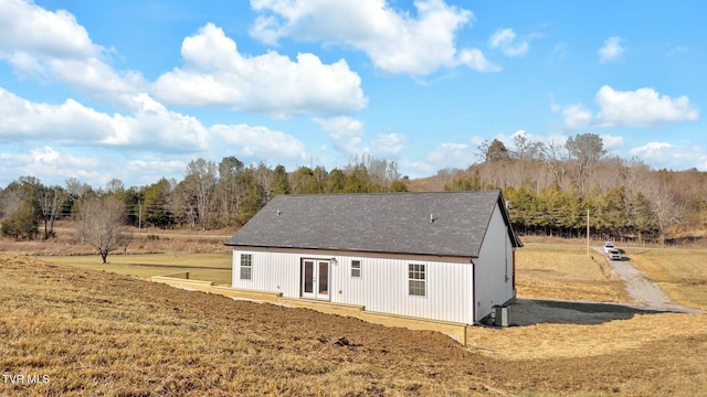 rear view of house with a lawn and french doors