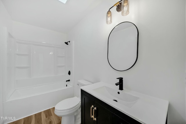 full bathroom featuring vanity, wood-type flooring,  shower combination, and toilet