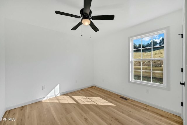 empty room with light hardwood / wood-style floors and ceiling fan