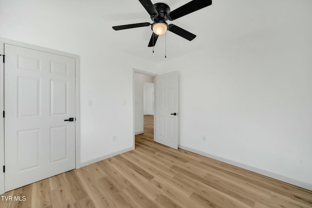 unfurnished bedroom featuring ceiling fan and light hardwood / wood-style flooring