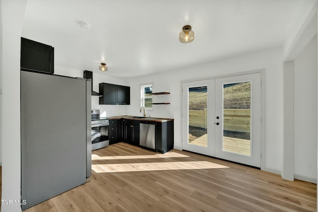 kitchen with sink, light hardwood / wood-style flooring, french doors, and appliances with stainless steel finishes