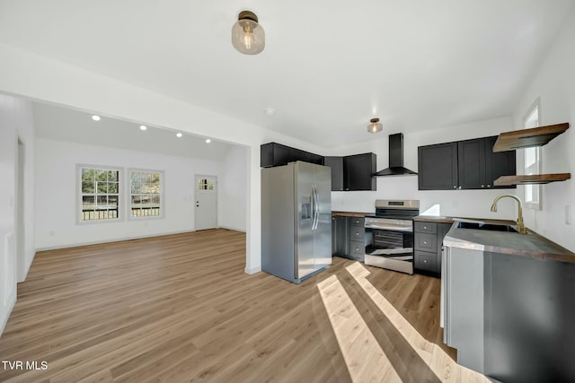 kitchen featuring sink, light hardwood / wood-style floors, wall chimney exhaust hood, and appliances with stainless steel finishes