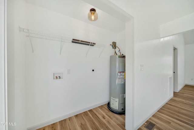 laundry room featuring hookup for a washing machine, electric water heater, hardwood / wood-style floors, and electric dryer hookup