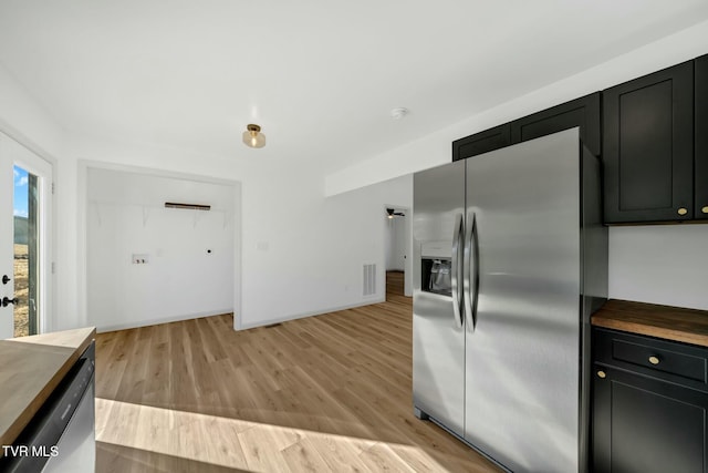 kitchen featuring butcher block countertops, stainless steel appliances, and light wood-type flooring