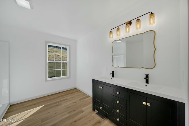 bathroom with wood-type flooring and vanity