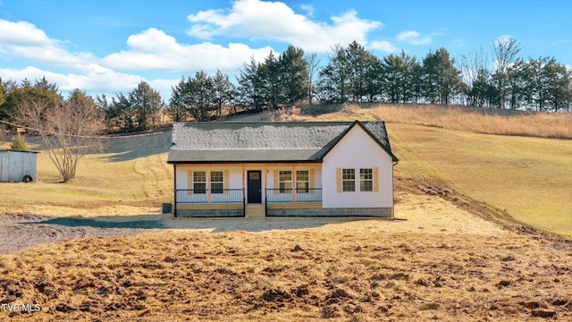 exterior space featuring a porch and a lawn