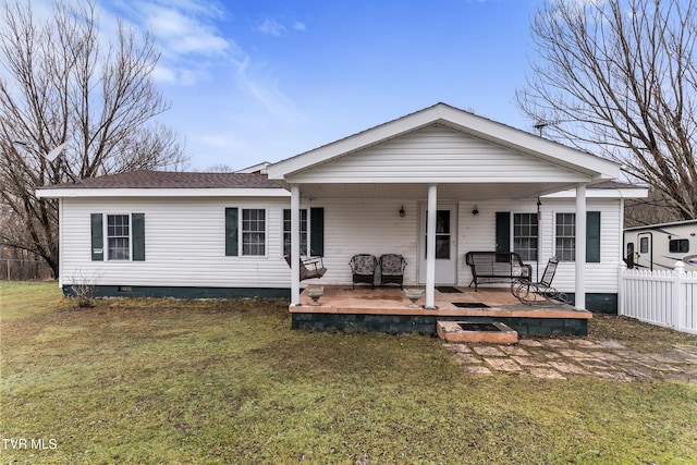 rear view of house with a porch and a yard