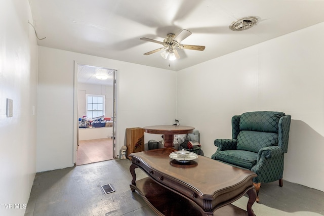 living area with ceiling fan