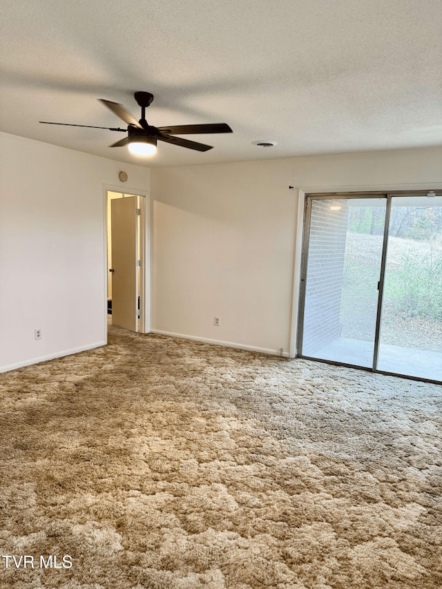 spare room with ceiling fan, carpet floors, and a textured ceiling