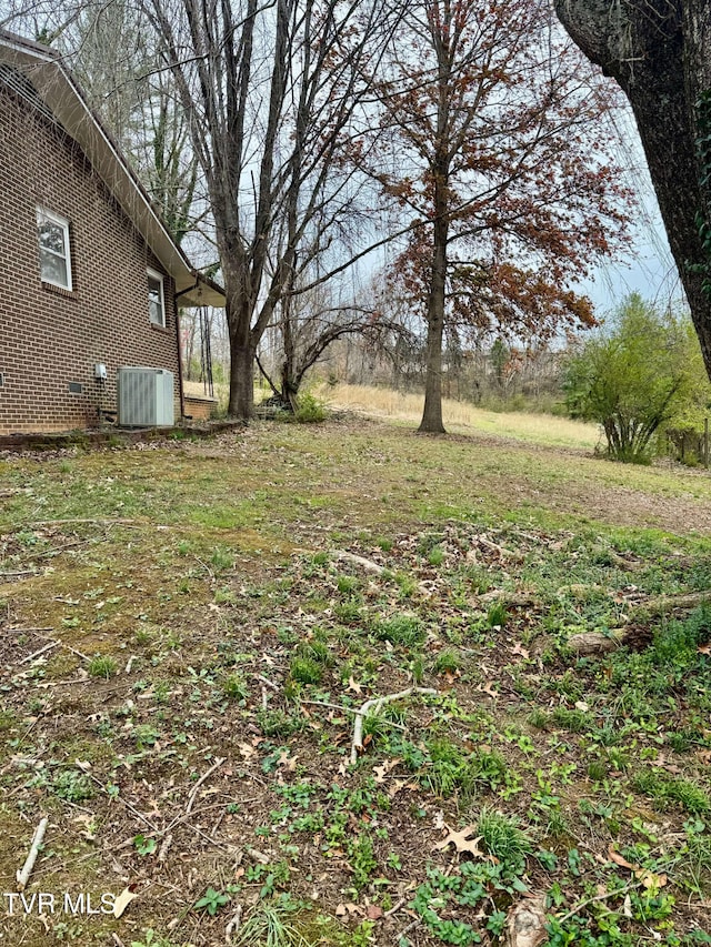 view of yard with central air condition unit