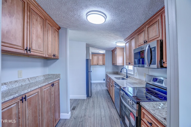 252 Scott Ln, Blountville, TN 37617 - kitchen with a sink, stainless steel appliances, brown cabinets, and light wood-type flooring