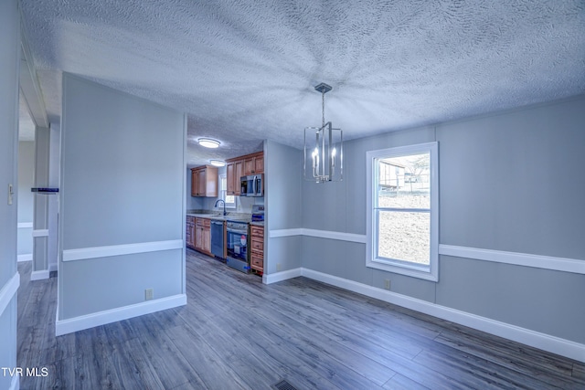 252 Scott Ln, Blountville, TN 37617 - unfurnished dining area with dark wood-type flooring, a textured ceiling, baseboards, and a notable chandelier