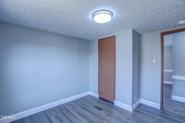 252 Scott Ln, Blountville, TN 37617 - spare room featuring visible vents, a textured ceiling, baseboards, and wood finished floors