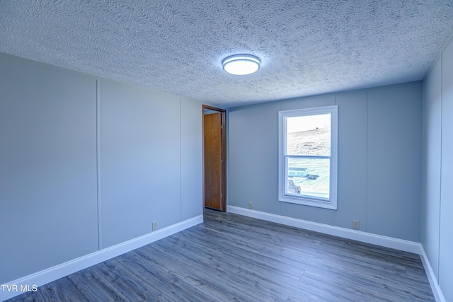 252 Scott Ln, Blountville, TN 37617 - unfurnished room with baseboards, a textured ceiling, and wood finished floors