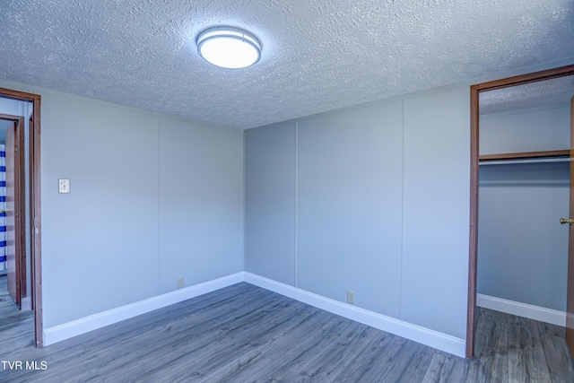 252 Scott Ln, Blountville, TN 37617 - unfurnished bedroom featuring a closet, a textured ceiling, baseboards, and wood finished floors